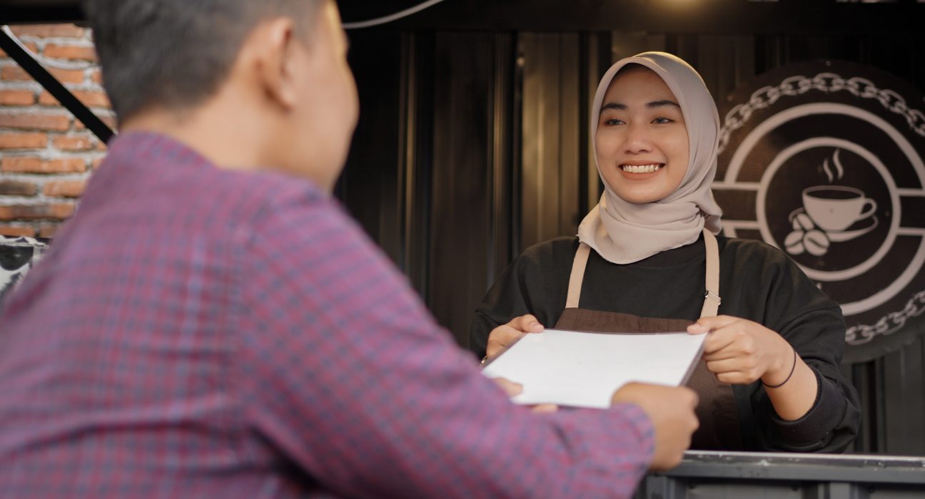 beautiful asian waitress giving a menu list to cus 2025 01 10 18 30 14 utc