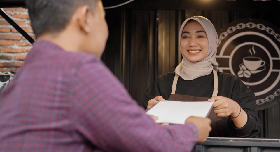 beautiful asian waitress giving a menu list to cus 2025 01 10 18 30 14 utc