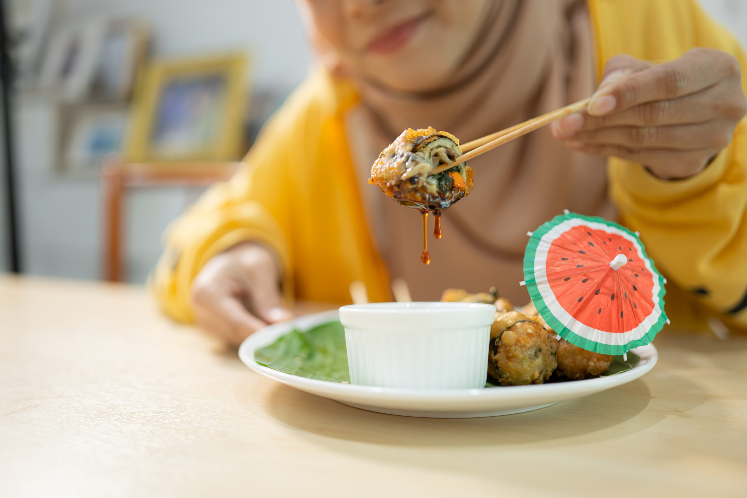 muslim girl eating mushroom sushi at the restauran 2025 01 07 06 08 48 utc scaled