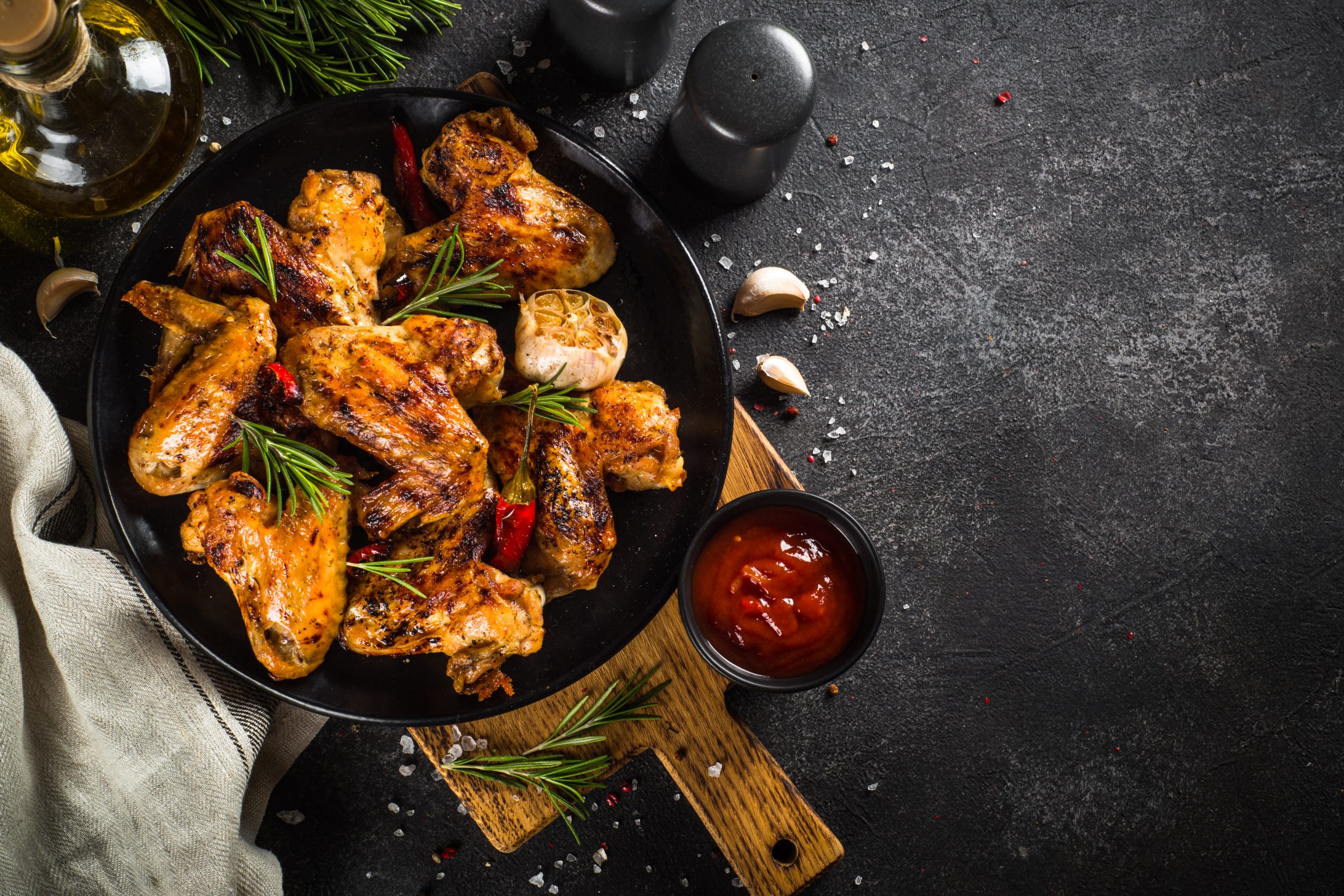 5 Easy Halal Chicken Dishes for Beginners 14 grilled chicken wings with spices at black table 2025 02 12 10 38 31 utc scaled