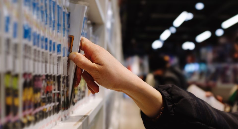 a person is reaching for a book on a shelf in a st 2024 12 08 00 26 53 utc