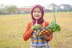 asian hijab woman wear apron hold vegetable and th 2025 01 10 18 21 02 utc