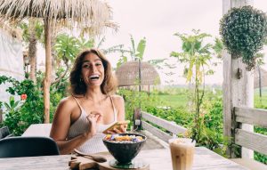 cheerful hispanic woman with healthy lunch bowl an 2025 03 25 15 29 16 utc