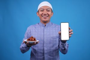 cheerful young muslim man showing blank screen sma 2025 03 04 20 39 38 utc