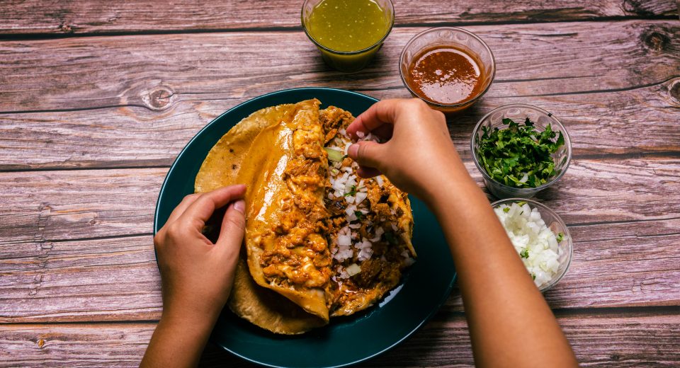 hands of a person preparing a gringa pastor a la d 2025 03 11 14 18 26 utc