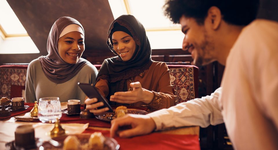 happy middle eastern friends using mobile phone wh 2024 12 13 18 51 54 utc