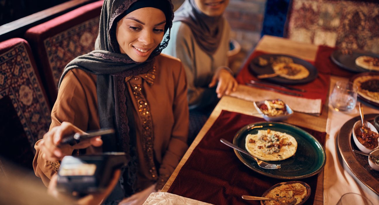 happy middle eastern woman paying contactless with 2024 12 13 21 27 53 utc