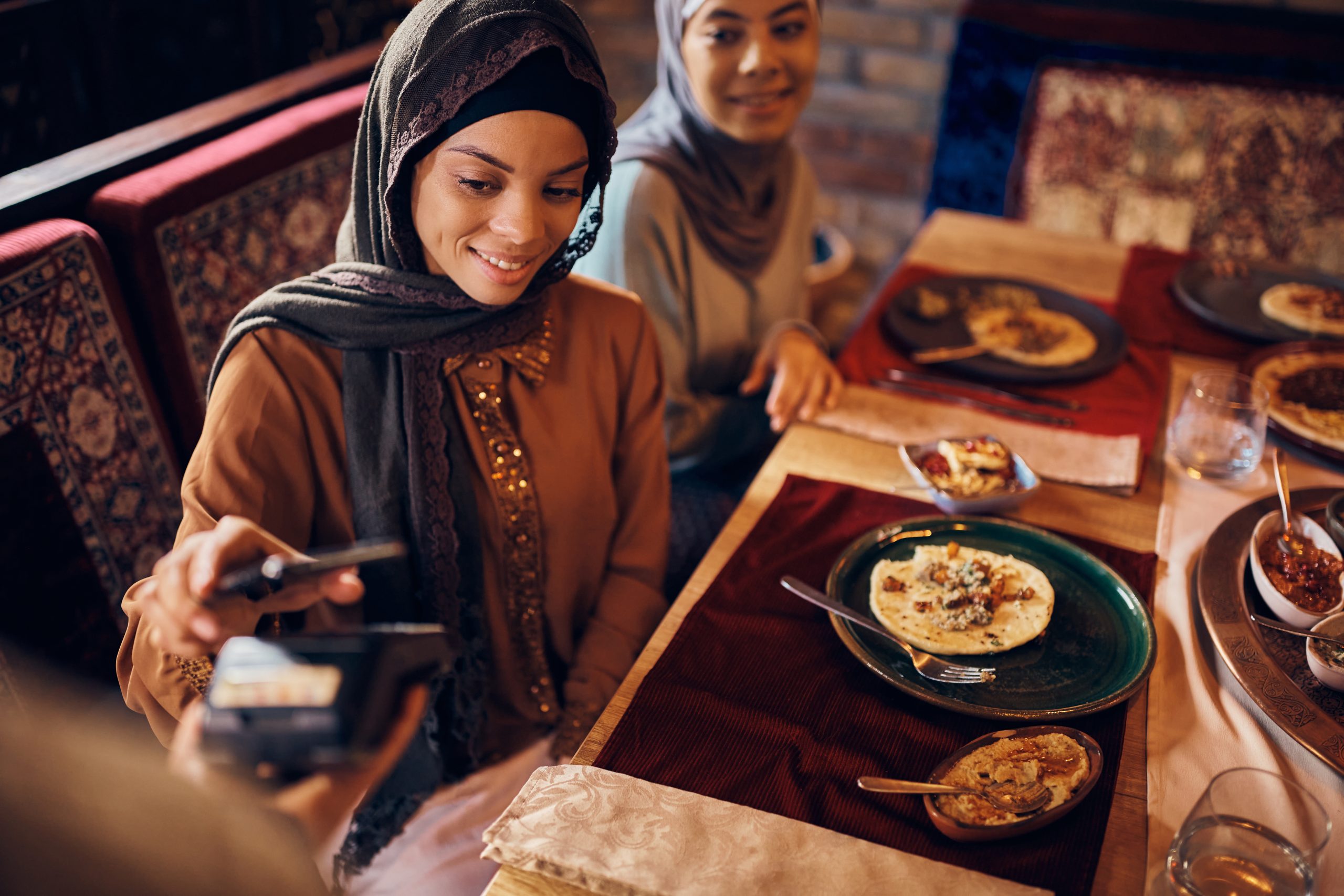 happy middle eastern woman paying contactless with 2024 12 13 21 27 53 utc scaled