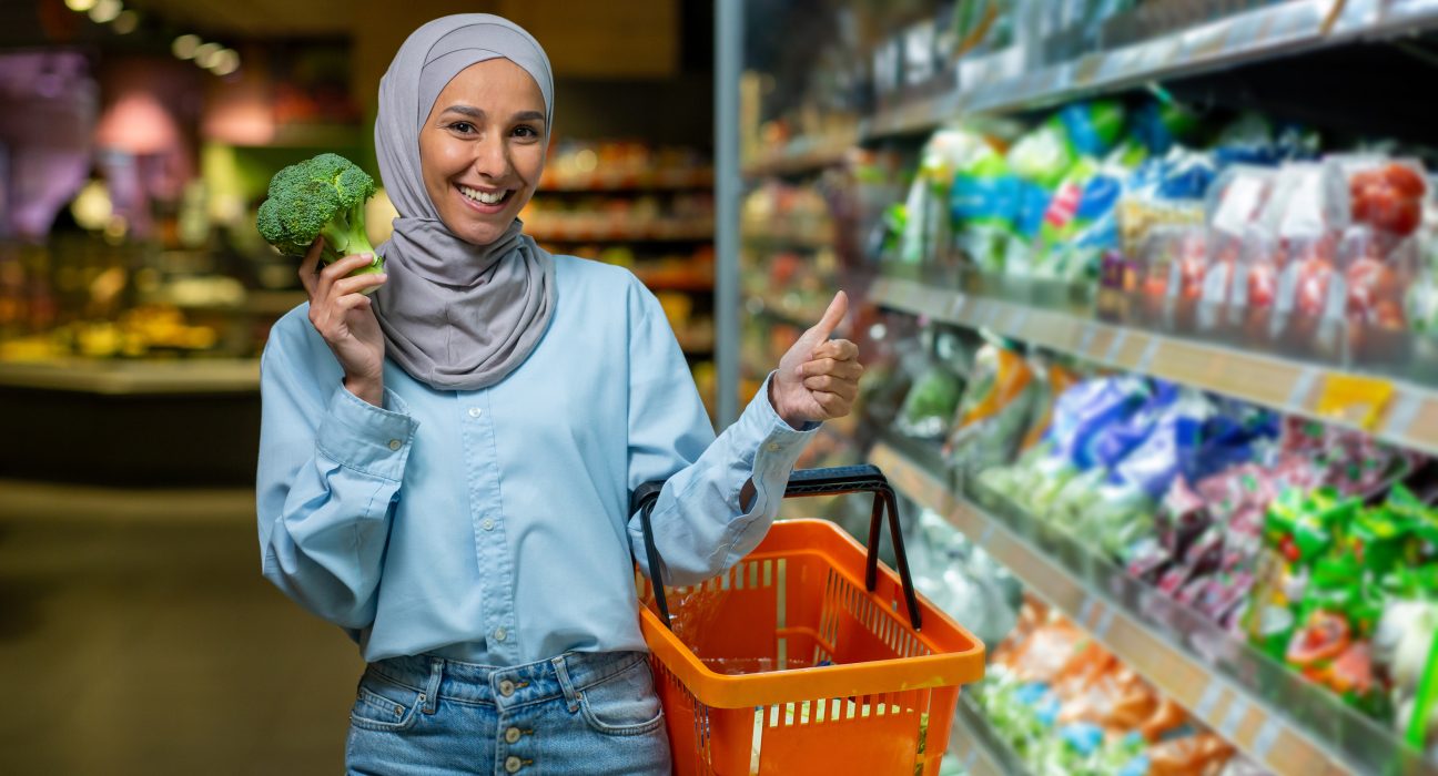 happy muslim woman in hijab standing in supermarke 2025 03 25 05 05 22 utc 1