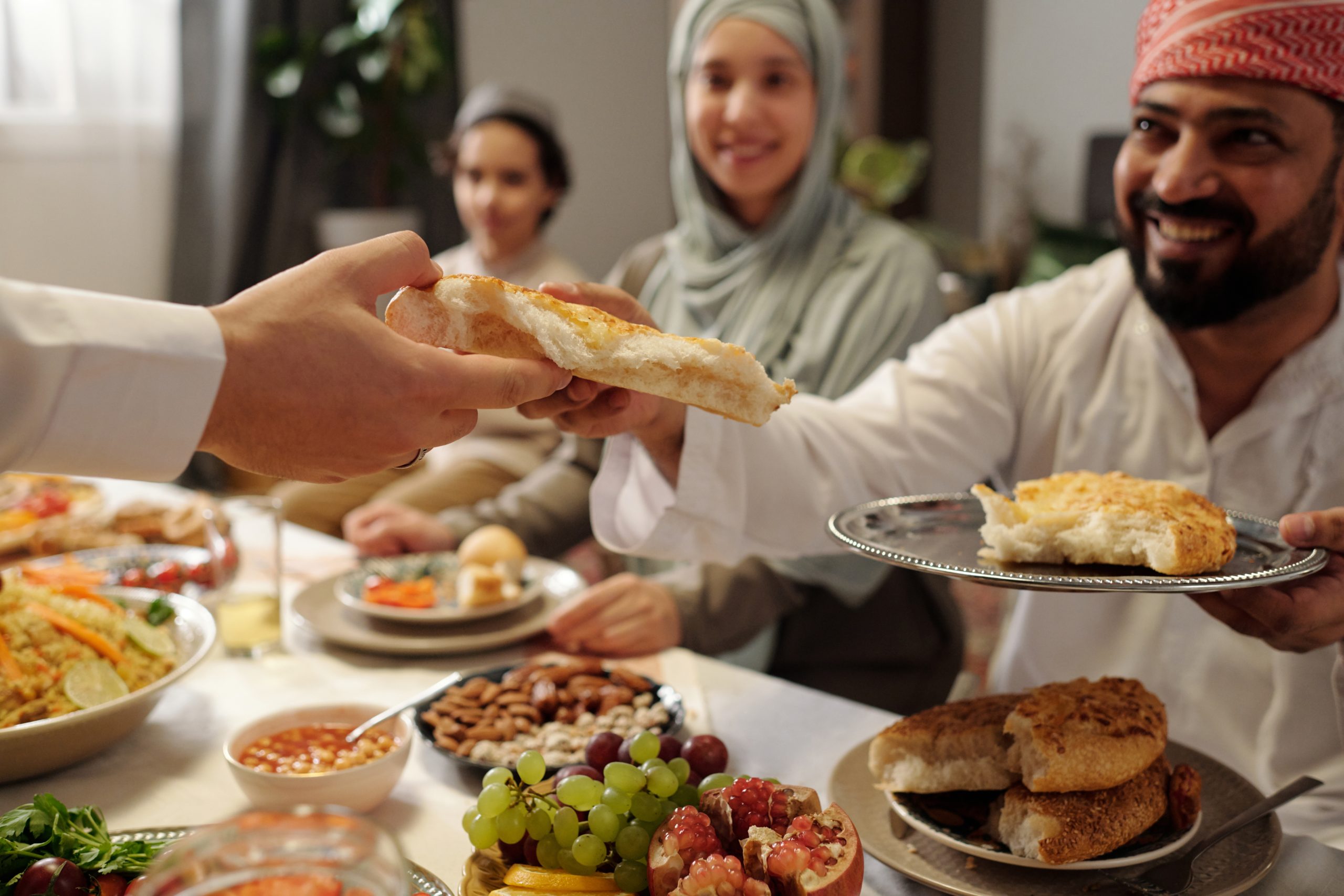 muslim family sharing flatbread at festive dinner 2025 03 15 04 17 28 utc scaled