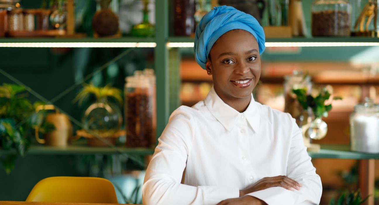 pretty young black woman sitting at cafe smiling 2025 03 18 18 45 01 utc