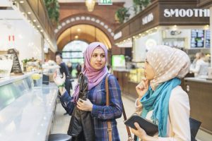 woman talking to friend at railroad station cafe 2024 10 16 15 23 58 utc