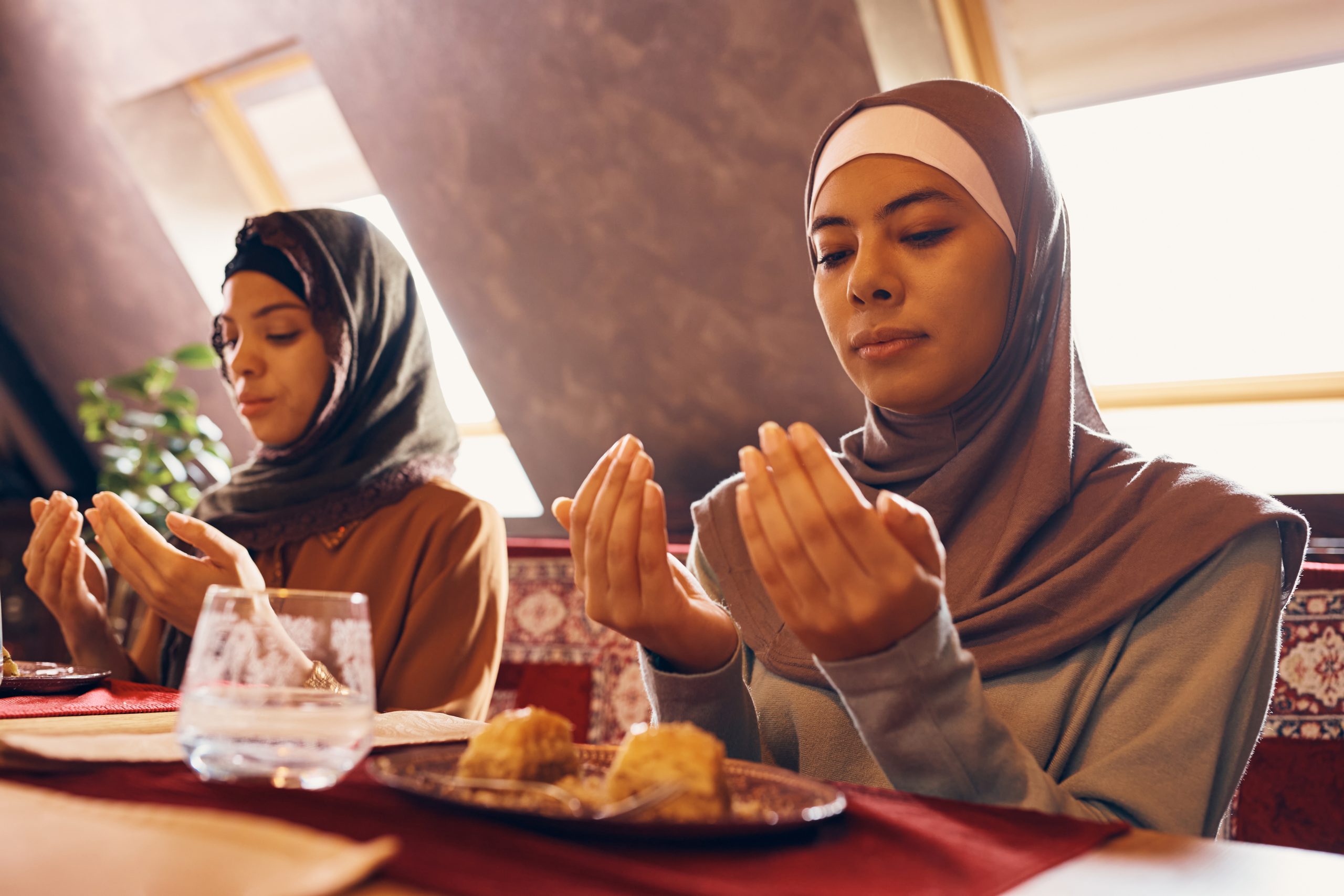 young muslim women praying while having dessert at 2024 12 13 18 32 21 utc scaled